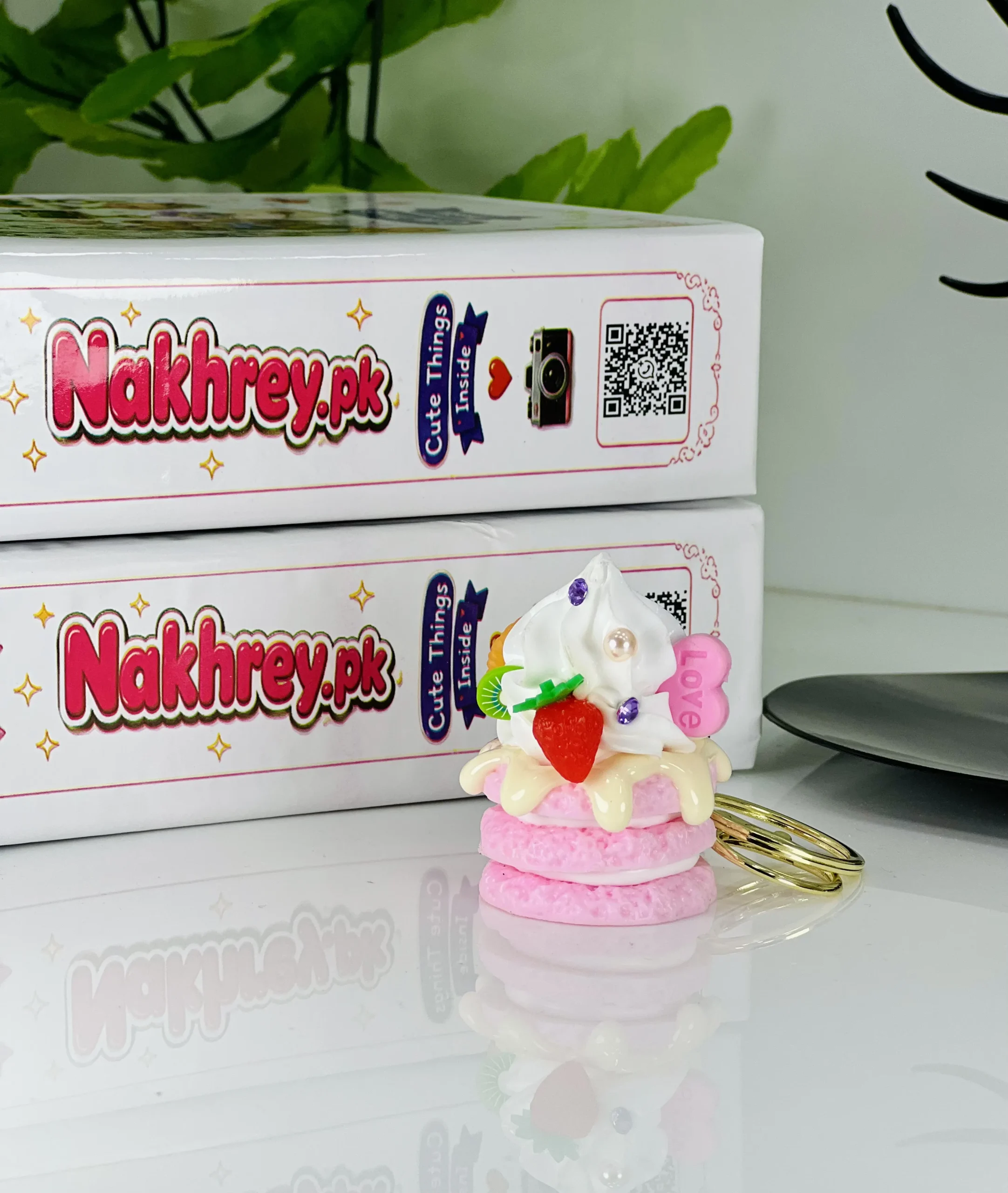Cute mini whipped cream cake keychain with strawberry and kiwi toppings
