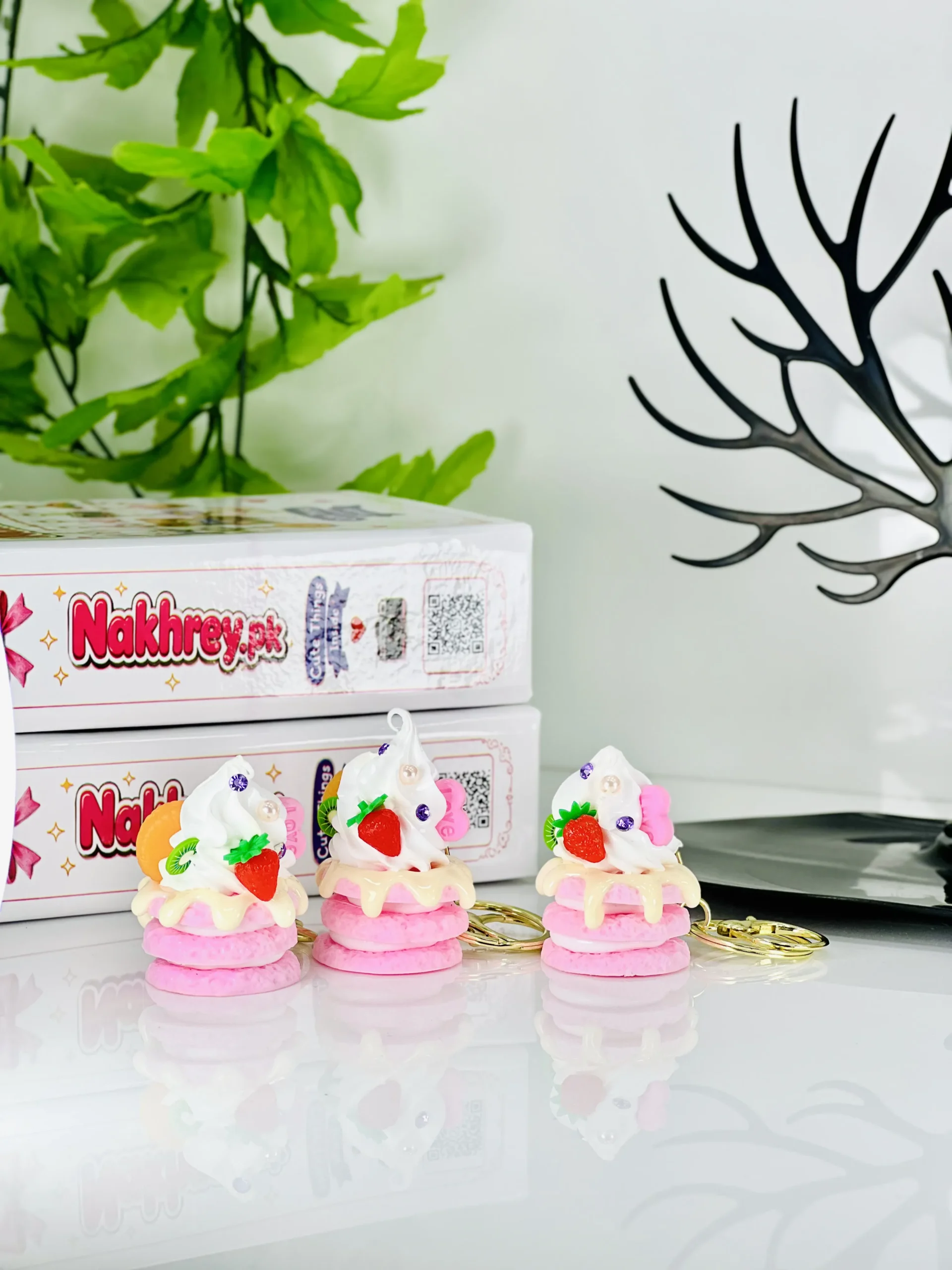 Cute mini whipped cream cake keychain with strawberry and kiwi toppings