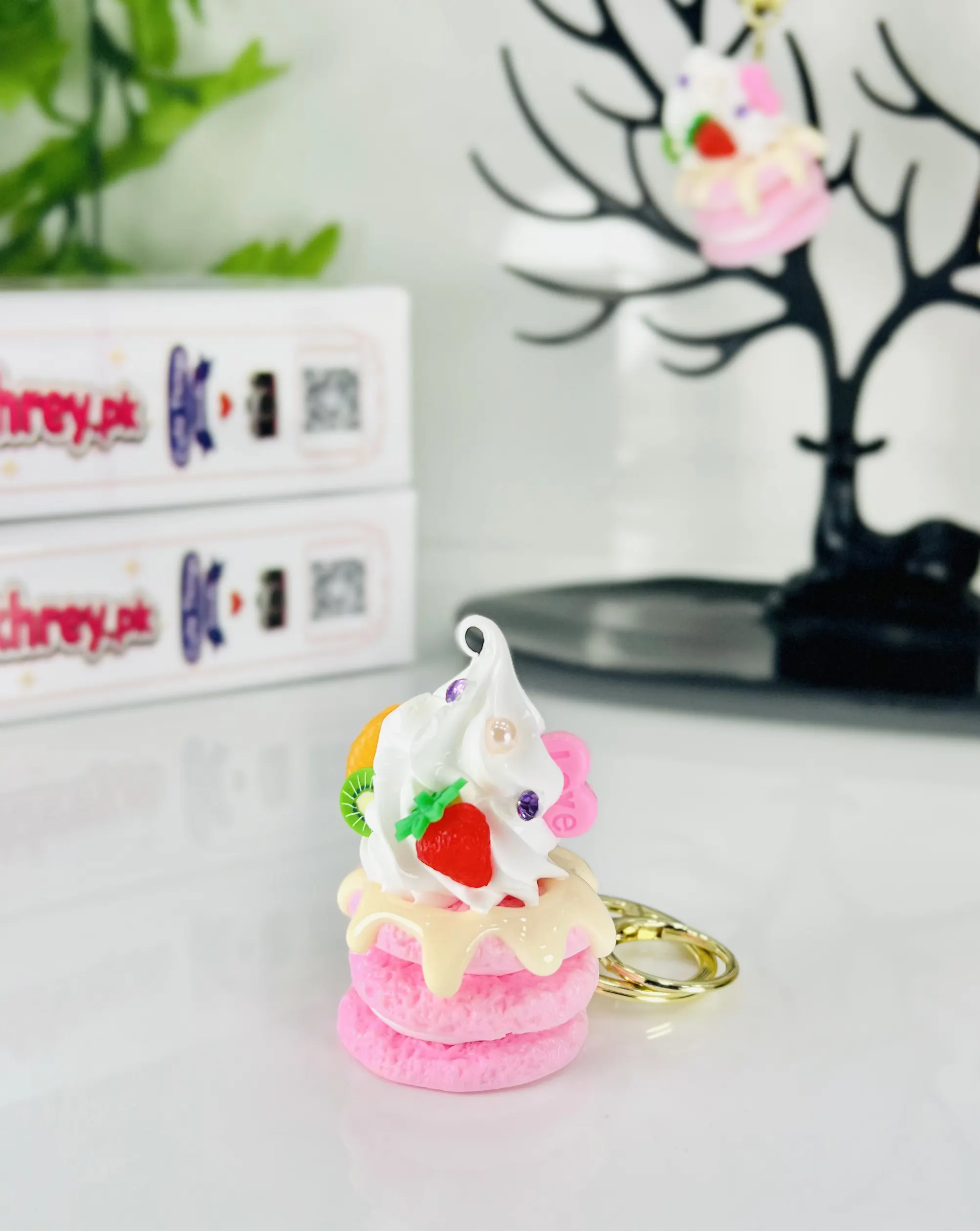Cute mini whipped cream cake keychain with strawberry and kiwi toppings