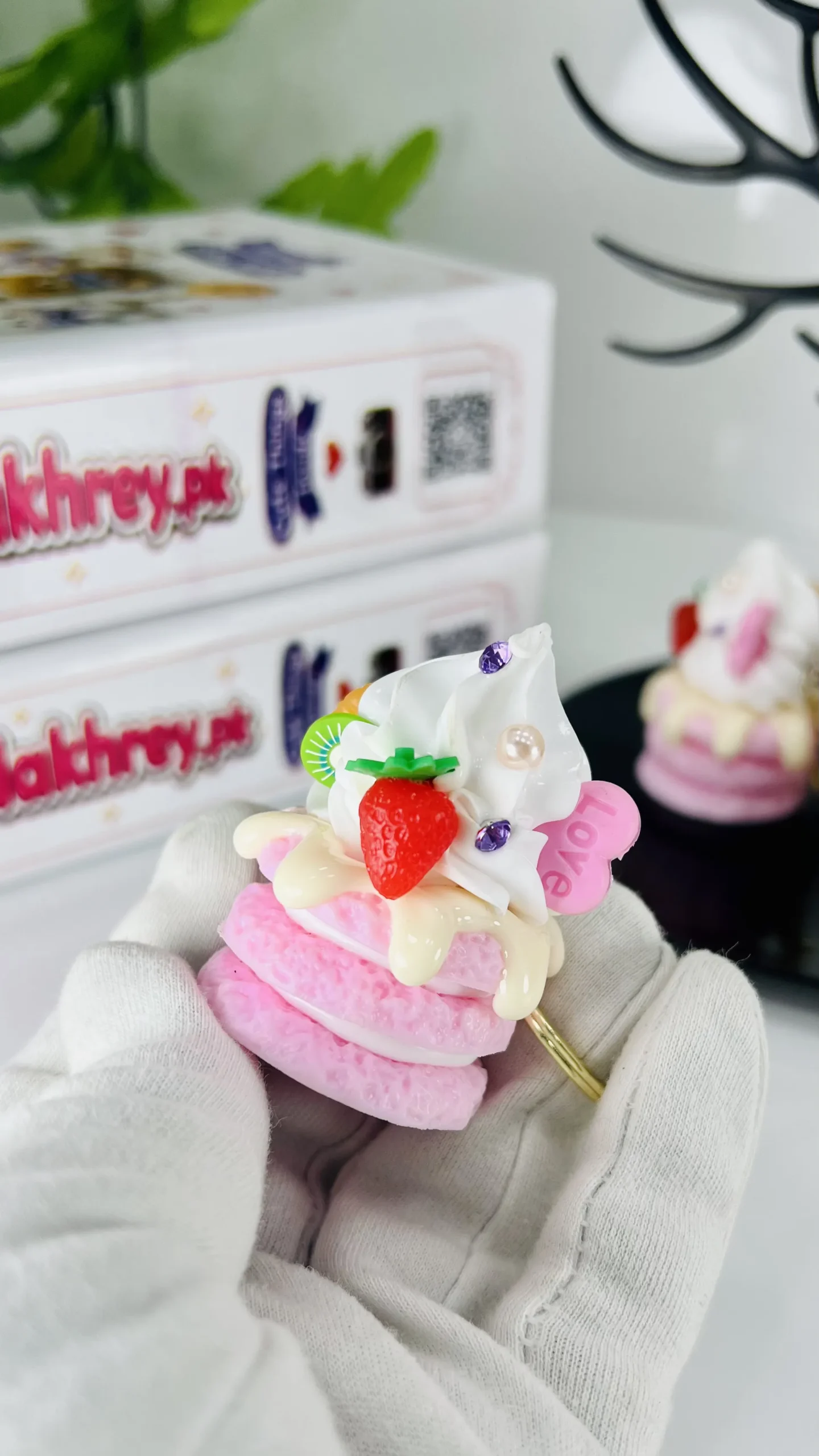 Cute mini whipped cream cake keychain with strawberry and kiwi toppings